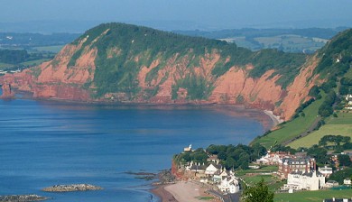 View of red cliffs and coastline near Oakdown Holiday Park on the Jurassic Coast in Devon